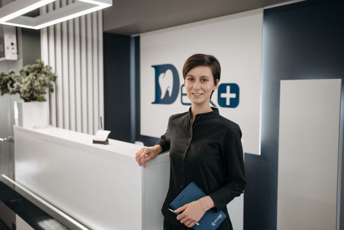 Receptionist at a dental clinic front desk