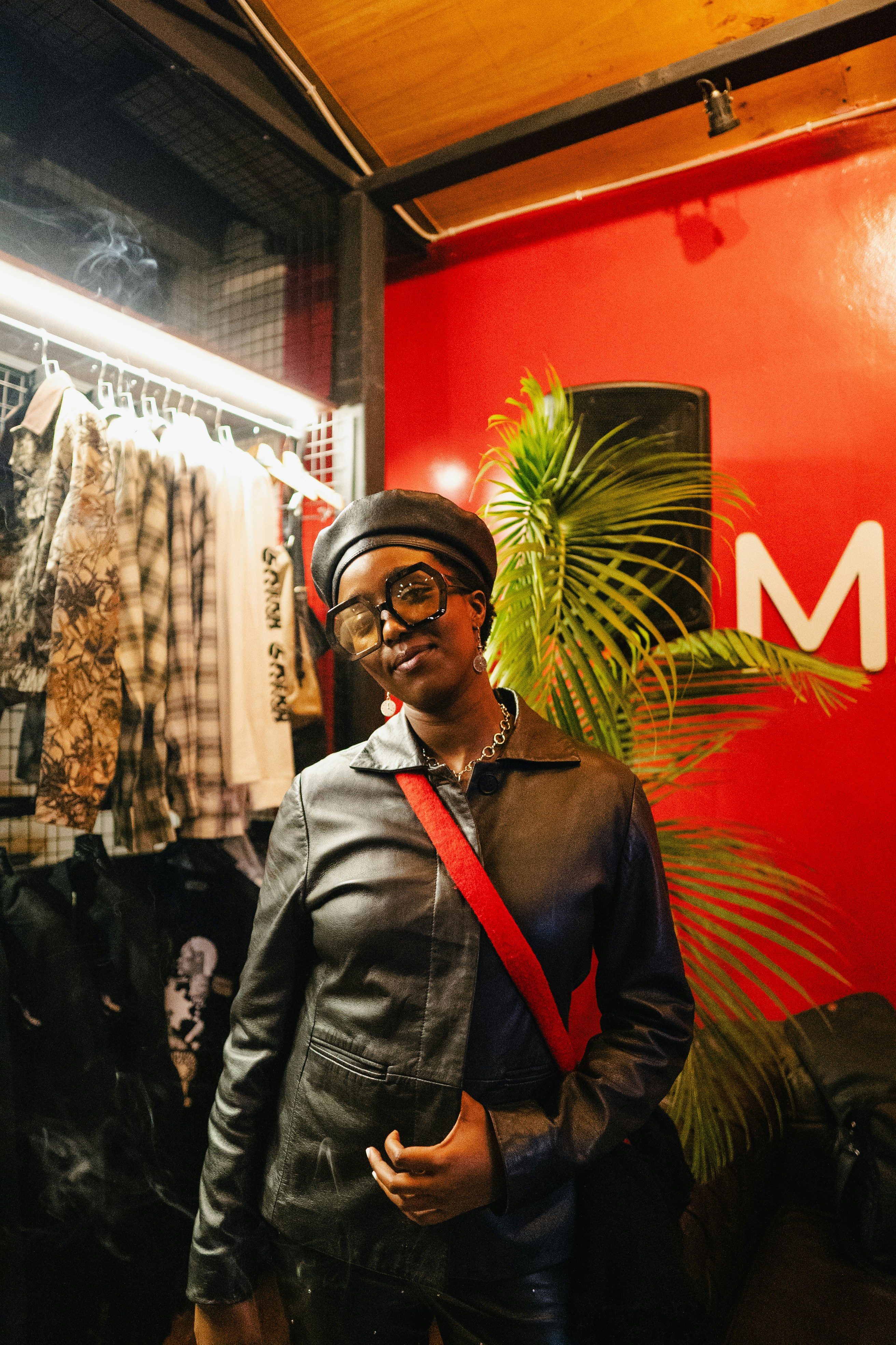 Fashion vendor smiling on a call in her studio