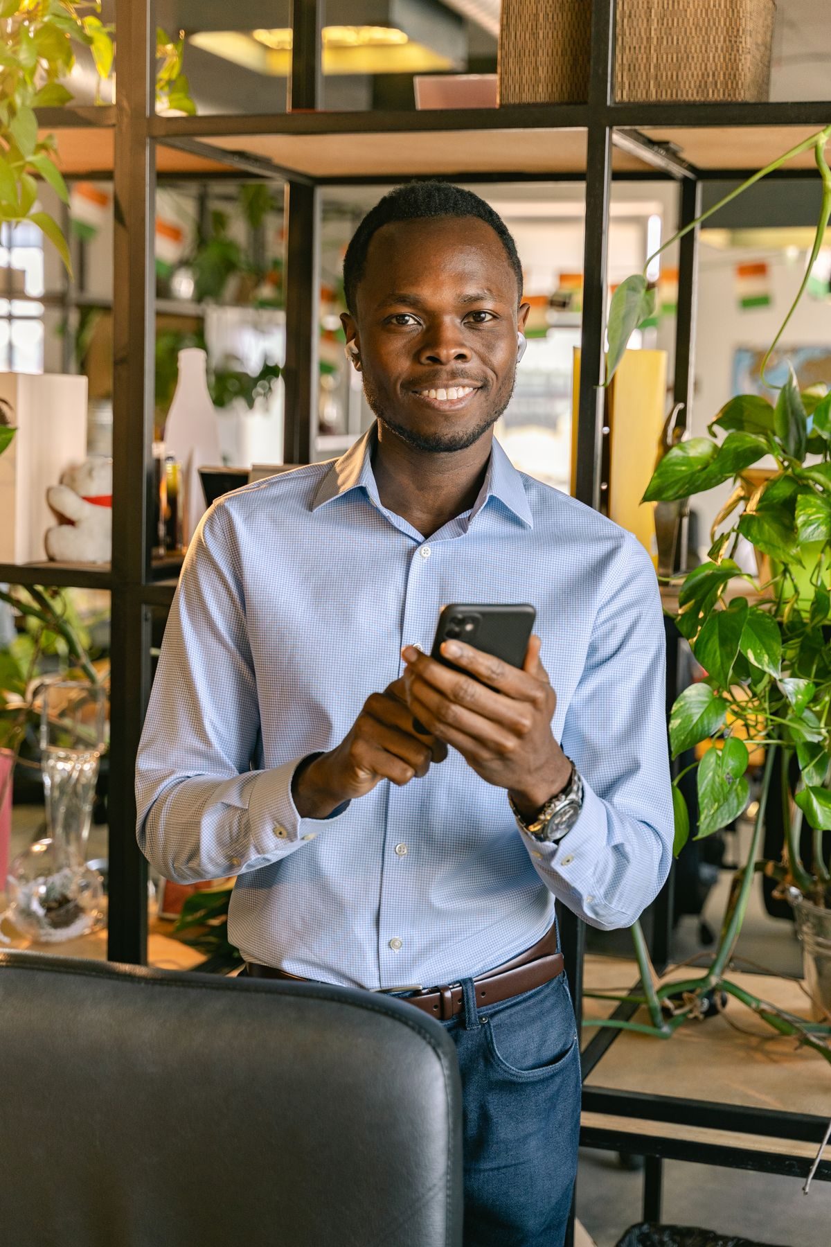 Business owner smiling at a message on his phone