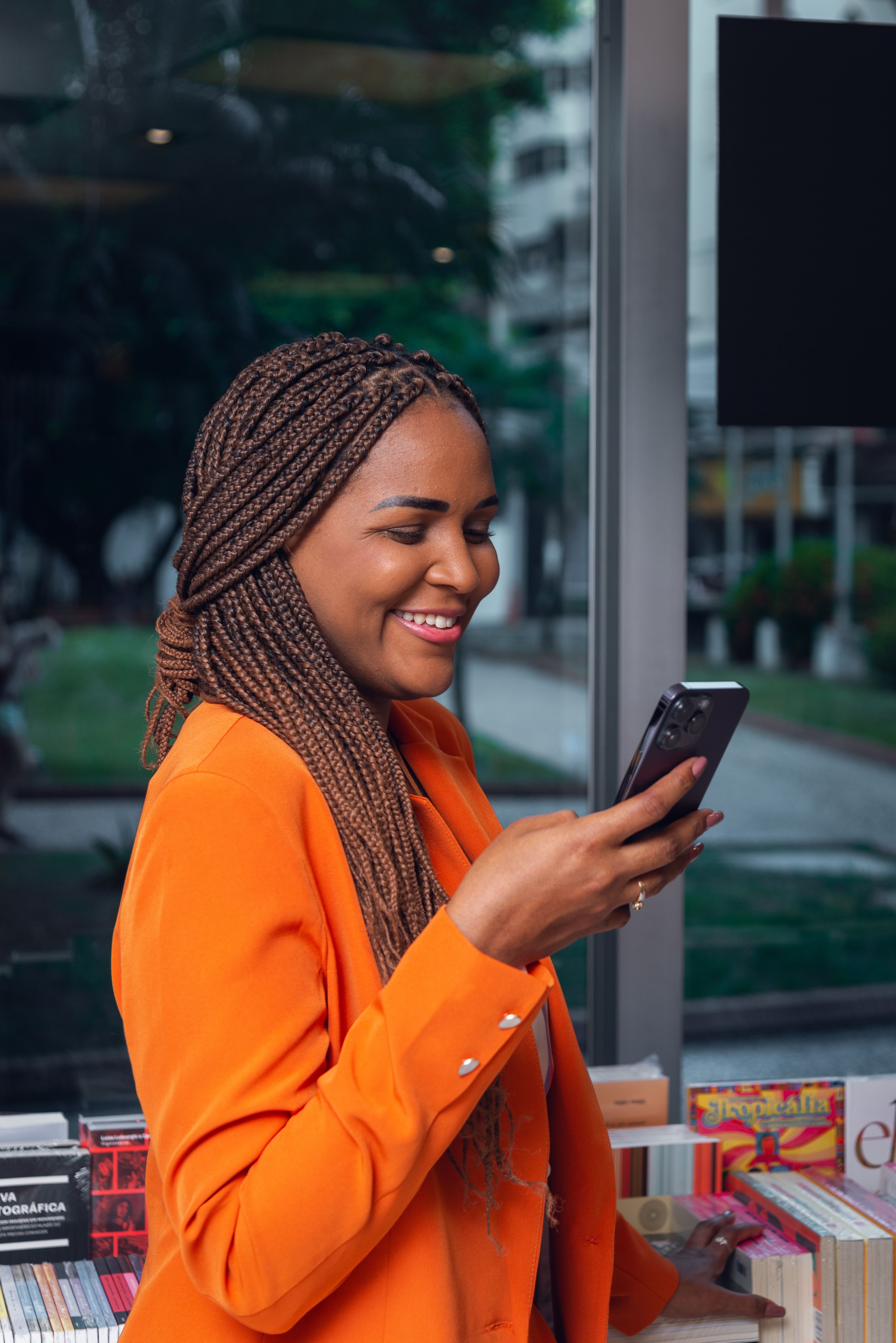 Business owner in an apron connecting her accounts on her phone