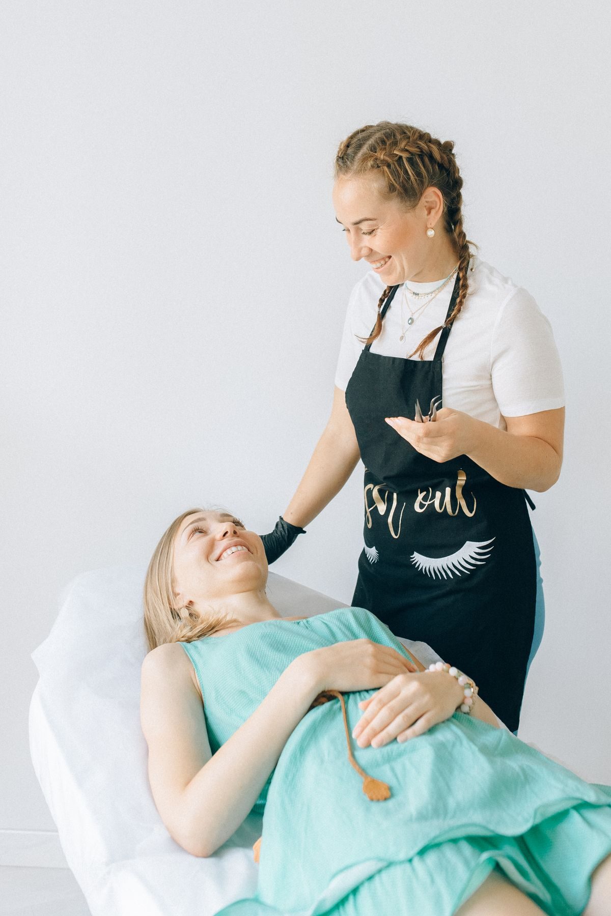 Therapist giving a facial treatment in a spa room